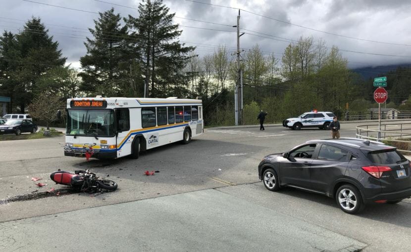 Officers with the Juneau Police Department block off traffic along Glacier Highway on Saturday, May 12, 2018 after a collision between a Capital Transit bus and a motorcycle. (Photo by David Purdy/KTOO)