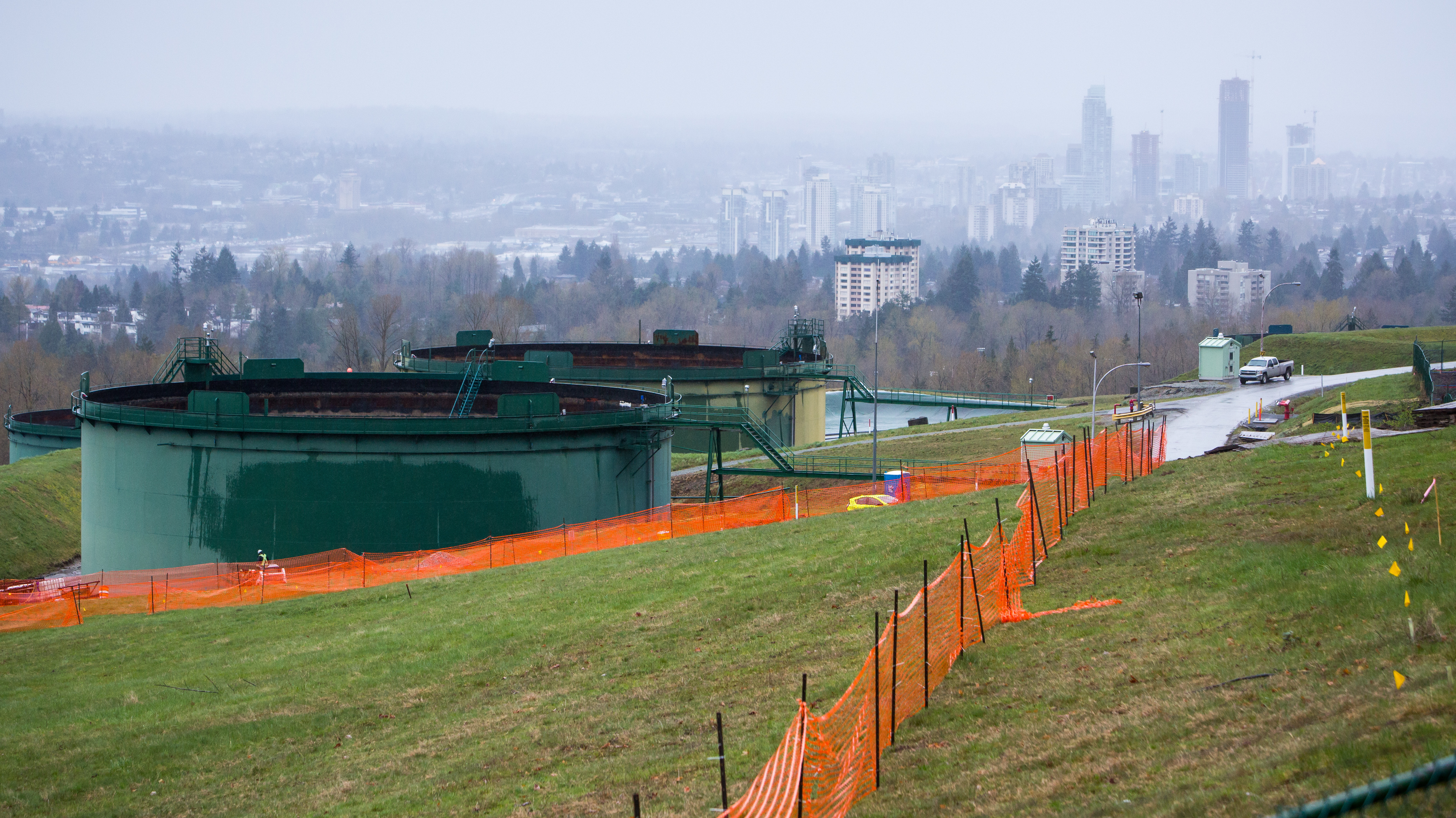The Canadian government is buying a pipeline expansion project in an effort to eliminate further derailment from protests and delays. Here, oil tanks stand near the Trans Mountain pipeline expansion site in Burnaby, British Columbia, in April. (Photo by Bloomberg via Getty Images)