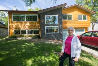 Former Alaska state legislator Alyce Hanley poses outside the apartment she had built into the bottom floor of her home in Sand Lake on Thursday, June 7, 2018. Hanley, who is 84, wanted to live with her children but have her own living space. (Loren Holmes/ADN)