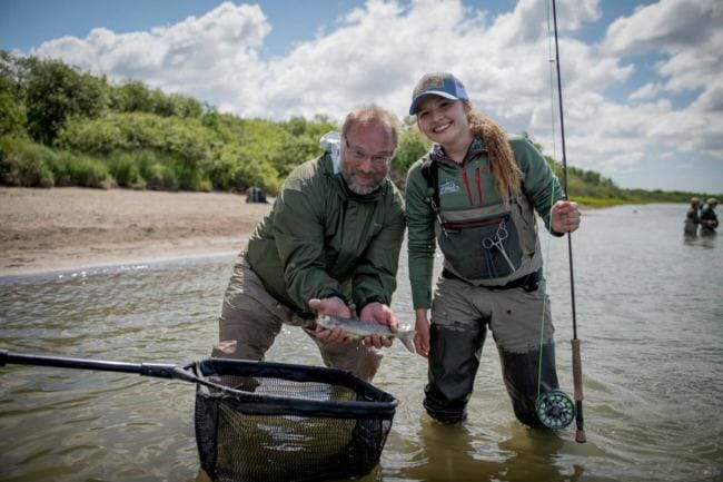 Byron Singley and Abbey Whitcomb pose with their fourth fish caught on the final day of the Bristol Bay Fly Fishing and Guide Academy. (Photo by Sarah Miller)