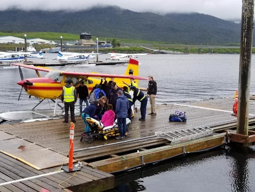 Emergency personnel help survivors of a floatplane crash at the Taquan dock in Ketchikan on June 1, 2018. A floatplane operated by Ketchikan-based RdM with seven people aboard had crashed on Prince of Wales Island.