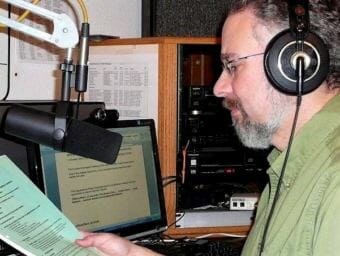 Ed Schoenfeld reads the news at KRBD in Ketchikan. After almost 19 years in print at the Juneau Empire, joining CoastAlaska was a homecoming: Schoenfeld had worked in radio in college, and at KINY and KTOO in Juneau in his early career.
