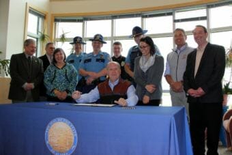 Gov. Bill Walker signs Senate Bill 148 on June 22, 2018. The bill will help villages to run background checks on future police officers, but it is voluntary for village police officers. (Photo courtesy Yuut Elitnaurviat)