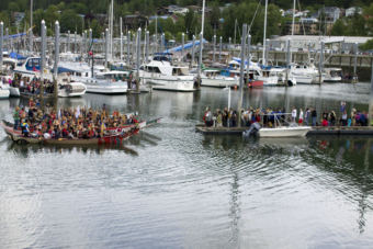 A group of canoes wait for permission from Native elders to land in Douglas Harbor on Tuesday, June 5, 2018.