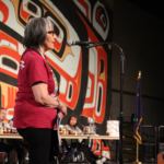 Rosita Worl on stage at Centennial Hall during the food competition. (Photo by Elizabeth Jenkins/Alaska's Energy Desk)