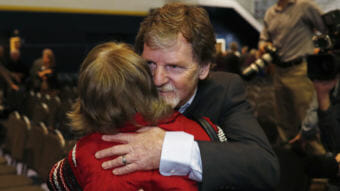 Jack Phillips, owner of Masterpiece Cake, is hugged by a supporter after a rally on the campus of a Christian college in November. (Photo by David Zalubowski/Associated Press)