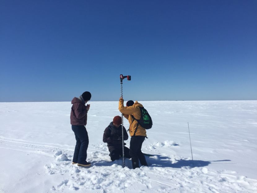 Arctic Field School students taking measurements on Elson lagoon as part of field school. Some of their time was spent getting instruction from professors, and some was spent working on answering research questions they formulated out in the field.