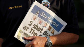 Staff of The Capital put out a newspaper on Friday, one day after a gunman killed five people in its offices at the Capital Gazette. Here, Steve Schuh, county executive of Anne Arundel County, Md., holds a copy of Friday's paper. (Photo by Joshua Roberts/Reuters)
