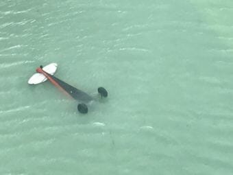 A Coast Guard Air Station Sitka helicopter aircrew locates a downed and inverted aircraft in Crillon Lake, in Glacier Bay National Park, Alaska, July 18, 2018. (Photo courtesy Coast Guard)