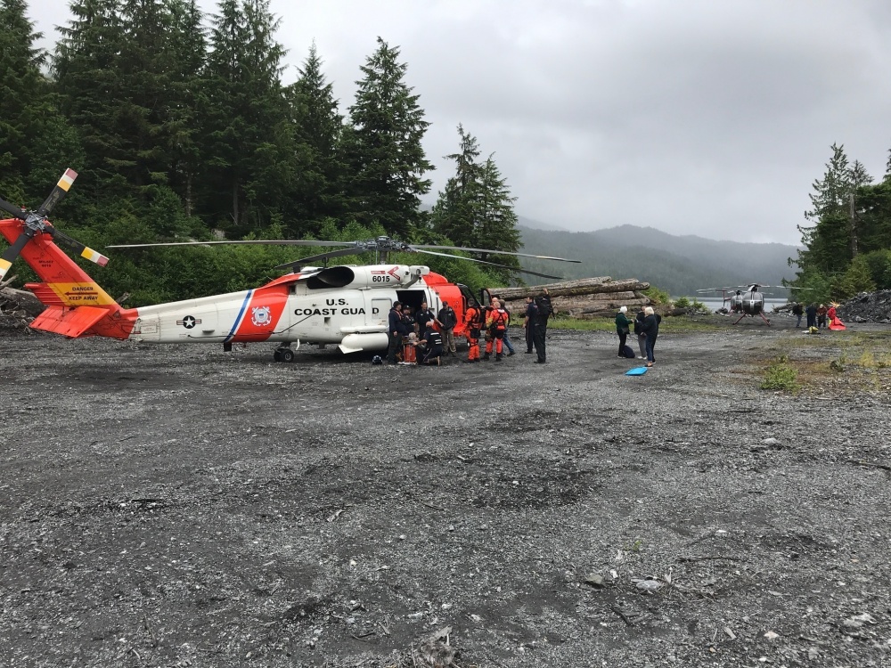 A Coast Guard Air Station Sitka MH-60 Jayhawk helicopter aircrew and Ketchikan Volunteer Rescue Squad personnel tend to survivors from a downed aircraft on Mount Jumbo on Prince of Wales Island, Alaska, July 10, 2018. All 11 people aboard the aircraft survived and were hoisted by a Jayhawk helicopter aircrew and taken to emergency medical personnel for triage before being further taken to Ketchikan for higher level medical care. (Photo courtesy U.S. Coast Guard photo)