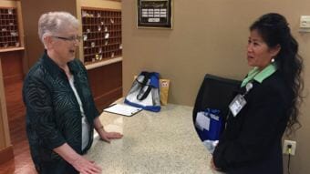 Kathleen Henry talks with a staffer at Greenspring retirement community in Springfield, Virginia. Henry leads voter registration at the precinct. (Photo by Pew Charitable Trusts)