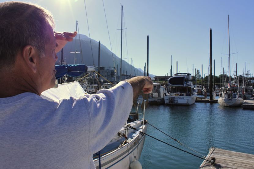 Jerry Nankervis points out a boat at Harris Harbor on July 29, 2018. (Photo by Adelyn Baxter/KTOO)