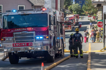 Capital City Fire/Rescue units line 4th street in response to a 3rd floor fire at the Mendenhall Towers on Thursday July 5th, 2018 (Photo by Mikko Wilson/KTOO)