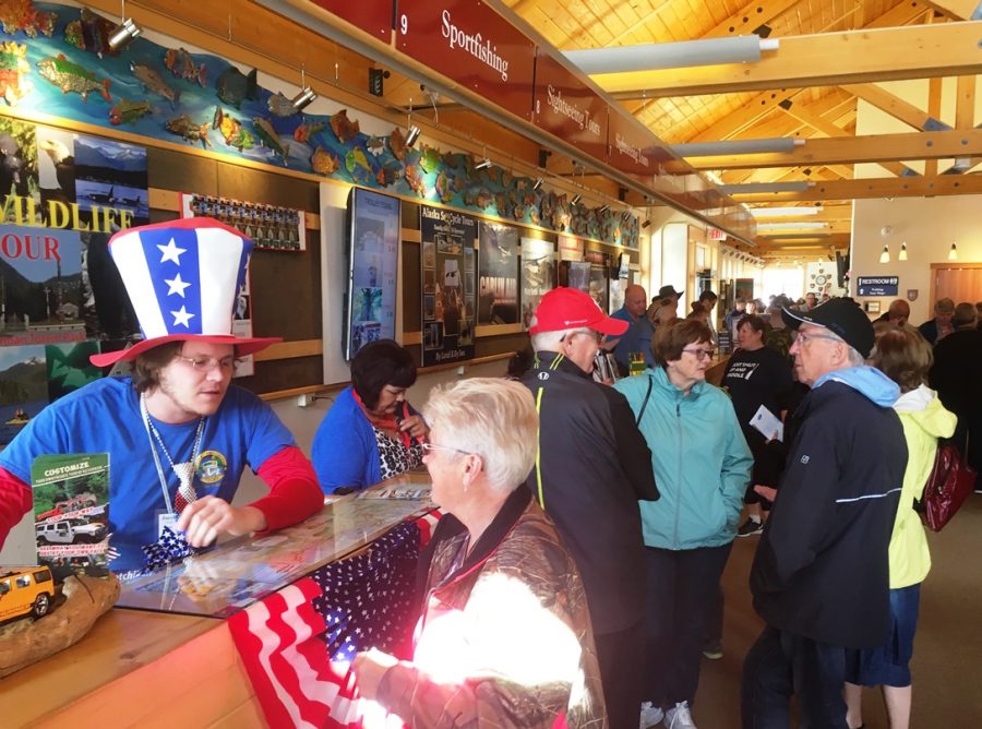 Cruise visitors wait in line at the Ketchikan Visitors’ Bureau building to buy shore excursions. (Photo by Leila Kheiry/KRBD)