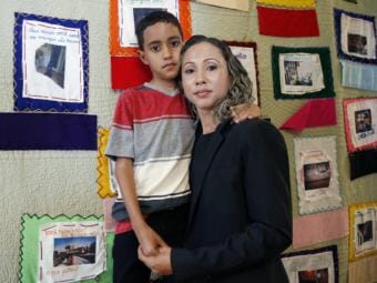 A Brazilian mother, who asked to be identified only as W.R., was reunified with with her 9-year-old son A.R. in Boston on July 16. (Photo by Michael Dwyer/Associated Press)