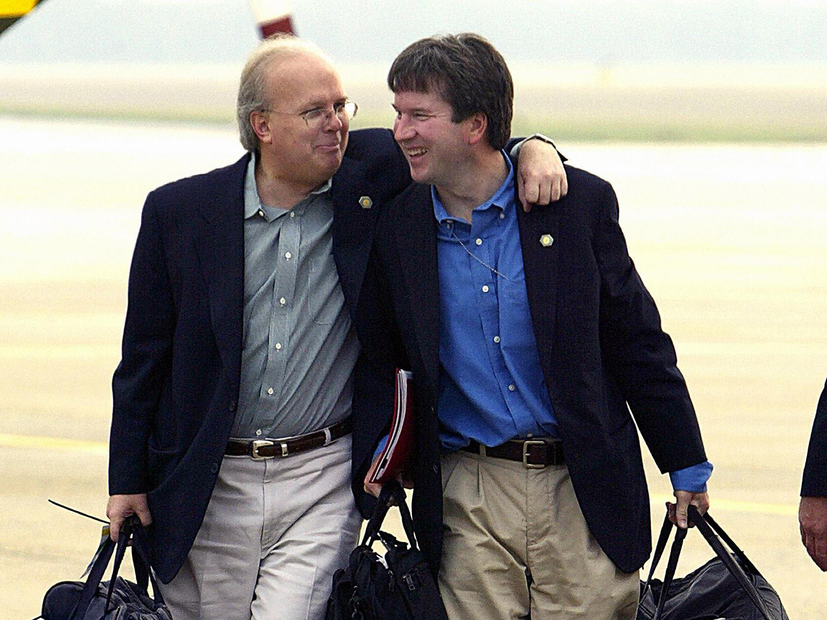 Presidential adviser Karl Rove, left, with Brett Kavanaugh in 2004. Kavanaugh was staff secretary in the White House at the time. (Photo by Paul J. Richards/AFP/Getty Images)