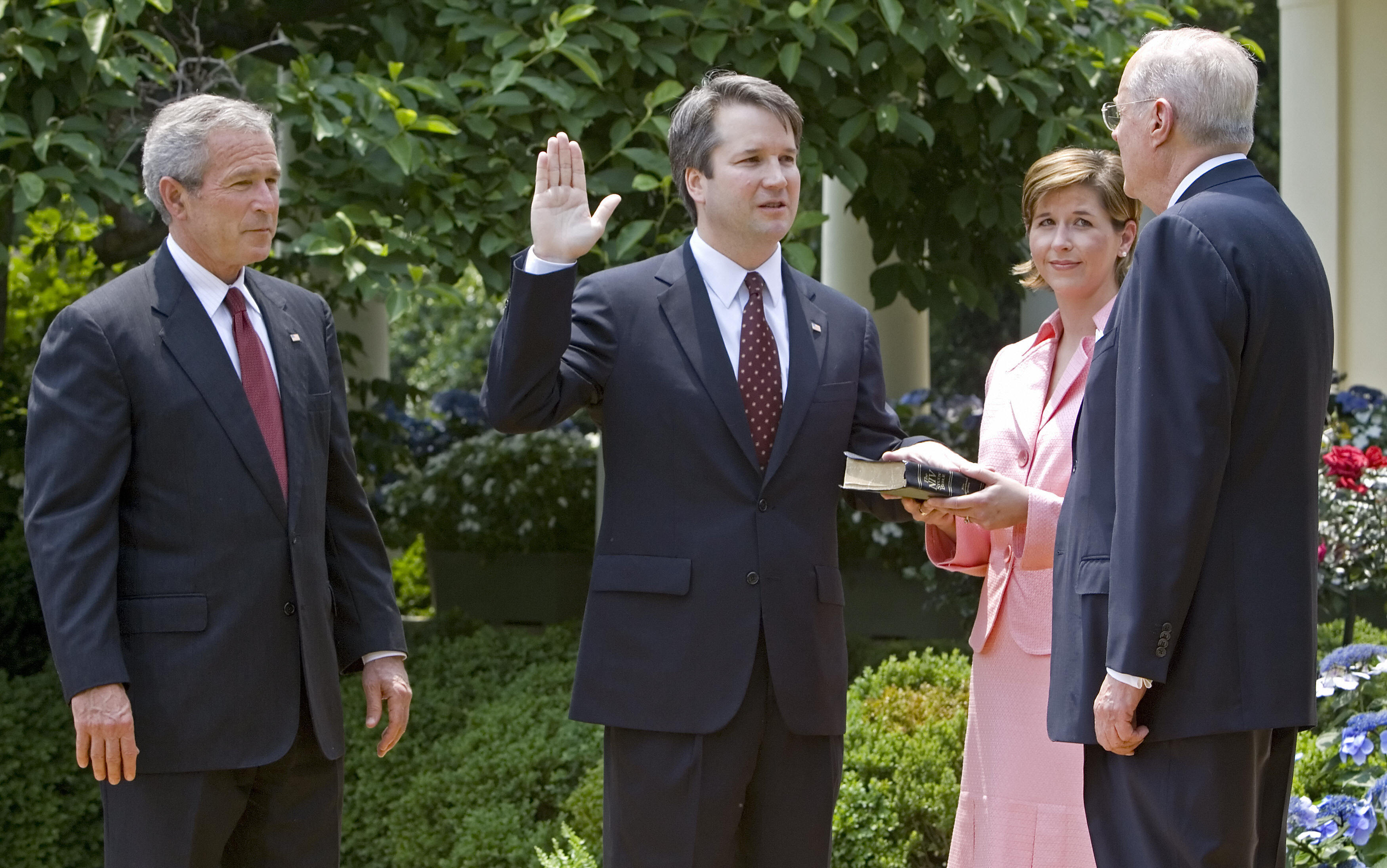 Brett Kavanaugh is sworn in as a federal judge by Supreme Court Justice Anthony Kennedy in 2006. President George W. Bush looks on. Kavanaugh is Trump's pick to replace Kennedy on the Supreme Court. (Photo by Paul J. Richards/AFP/Getty Images)