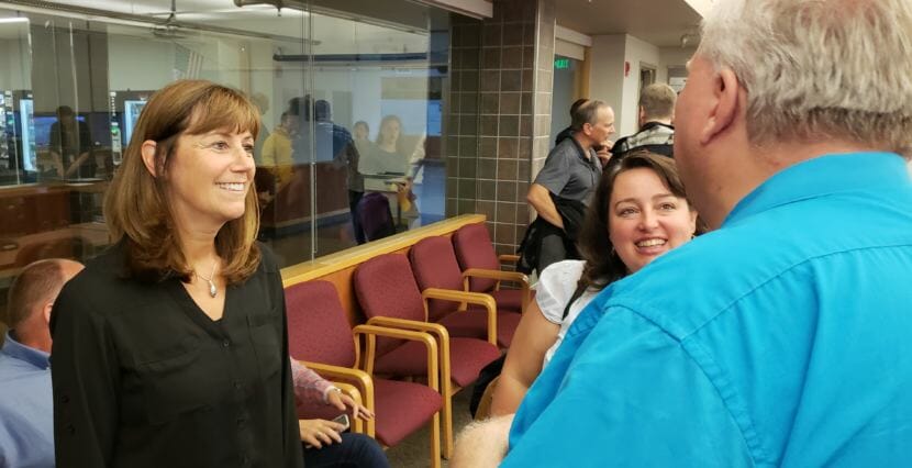 Juneau School Board member Emil Mackey congratulates Bridget Weiss for being selected interim superintendent of the Juneau School District on Monday, Aug. 6, 2018.