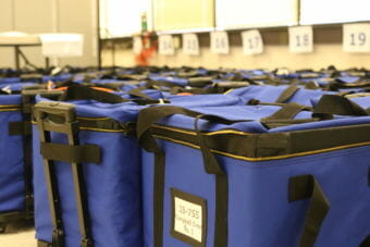 Election materials sit at the Anchorage offices of the Alaska Division of Elections on Tuesday, August 28, 2018. (Photo by Nathaniel Herz / Alaska's Energy Desk)