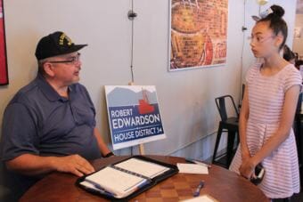 Candidate for state House Rob Edwardson speaks with Isis Reilly as Sacred Grounds Cafe on July 14, 2018. (Photo by Adelyn Baxter/KTOO)