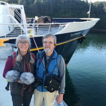 Documentarians Lucy Peckham and Michael Sakarias, pictured here in front of the Alaska Marine Highway System's ferry Tustumena in Kodiak on Wednesday, Aug. 22, 2018, are collecting stories about the ship.