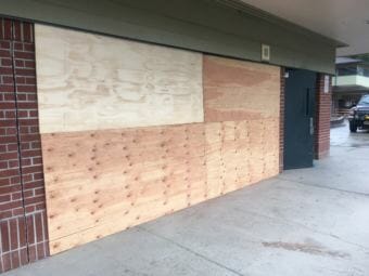 A portion of Dzantik'i Heeni Middle School is boarded up Friday, Aug. 3, 2018, after a Jeep crashed into the school earlier in the week. (Photo by Matt Miller/KTOO)