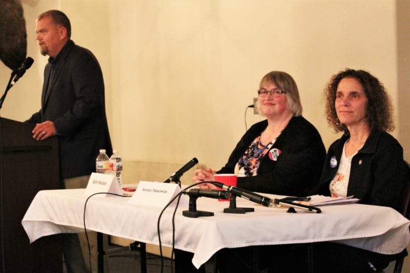 Juneau Chamber of Commerce President-elect Mike Satre introduces mayoral candidates Beth Weldon, left, and Saralyn Tabachnick, right, at a candidate forum on Sept. 27, 2018. Norton Gregory joined by phone. (Photo by Adelyn Baxter/KTOO)