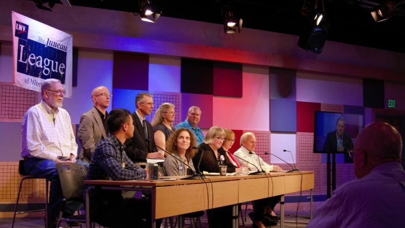 Juneau Assembly candidates on stage and a live audience @360 watch District 2 candidate Garrett Schoenberger's pre-recorded statement at the Juneau League of Women Voters Municipal Candidates Forum on Sept. 20, 2018. Back row from left to right: Loren Jones, Wade Bryson, Don Habeger, Michelle Bonnet Hale, Emil Mackey. Front row: Norton Gregory, Saralyn Tabachnick, Beth Weldon, Carole Triem and Tom Williams.