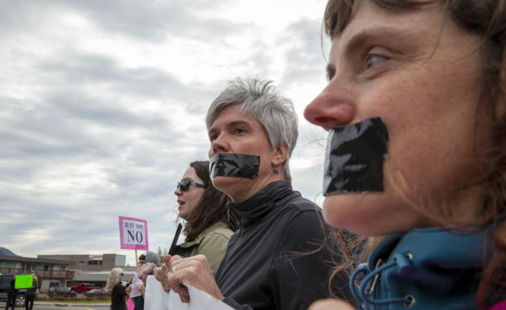 Cheryl Fellman, left, and Kristin Cox, silently protest outside of U.S. Sen. Lisa Murkowski's office in Juneau against the confirmation of Brett Kavanaugh to the U.S. Supreme Court on Sept. 28, 2018.