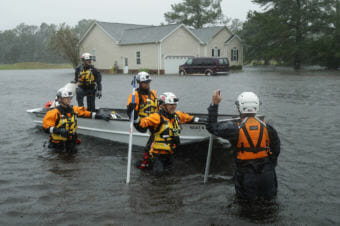 Members of the FEMA Urban Search and Rescue Task Force 4 search a flooded neighborhood for people who may have been trapped by the rising floodwaters during now-tropical storm Florence in North Carolina.