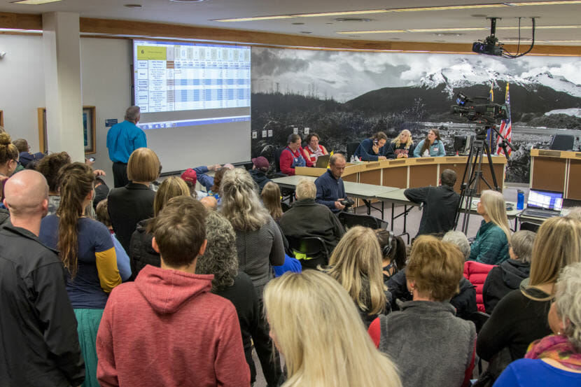 People watch election Juneau municipal returns come in at city hall on election night, Oct. 2. 