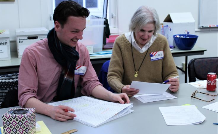 Canvass Review Board members Zebadiah Bodine and Mary Foster verify absentee ballots from the Oct. 2 election on Oct. 5, 2018. (Photo by Adelyn Baxter/KTOO)