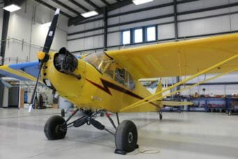 Yellow airplane in a hangar.