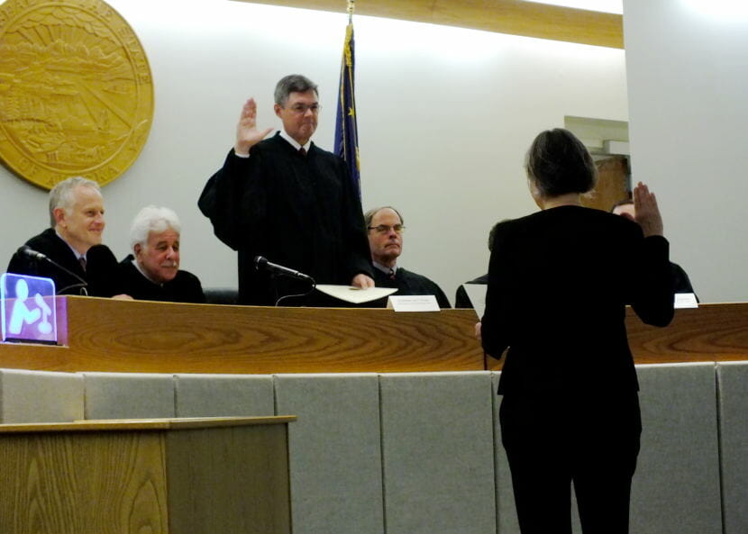 Alaska Supreme Court Chief Justice Joel Bolger administers the oath of office to Superior Court Judge Amy Gurton Mead. Watching, seated from far left, is Juneau Superior Court Judge Philip Pallenberg, Senior Judge Louis Menendez, and Ketchikan Superior Court Judge William Carey.