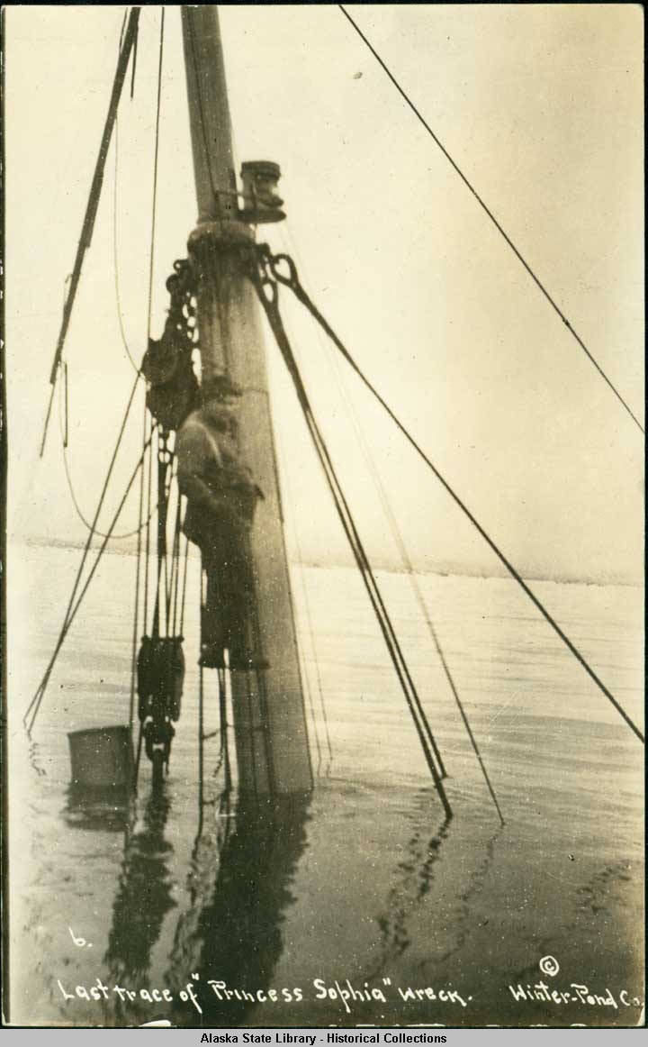 This archival photograph shows a man standing on the mast of the sunken Princess Sophia. (Photo courtesy of Alaska State Library)