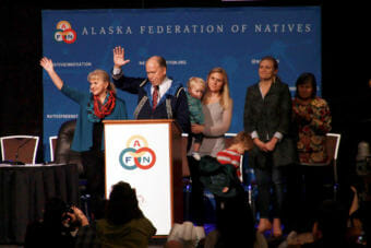 Alaska Gov. Bill Walker, with his family and recently sworn-in Lt. Gov. Valerie Davidson, waves to the audience shortly after announcing he would not seek re-election at the Alaska Federation of Natives convention Friday, Oct. 19, 2018, at the Dena'ina Center in Anchorage.