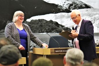 New Juneau Mayor Beth Weldon laughs as outgoing Mayor Ken Koelsch says his goodbyes on Oct. 15, 2018. (Photo by Adelyn Baxter/KTOO)