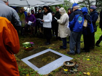 Tess Altiveros (white coat, center) of The Princess Sophia opera sings Sophia's Lullaby at the gravesite of Walter and Frances Harper at the Evergreen Cemetery.