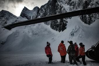 Members of Juneau Mountain Rescue and partner organizations stand on the Juneau Icefield looking up at the Mendenhall Towers. (Photo by Mike Janes)