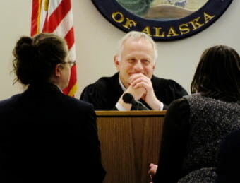 Public Defender Deborah Macaulay (left), Juneau Superior Court Judge Philip Pallenberg (center), and Assistant District Attorney Amy Paige (right) hold a bench conference during jury selection in the Mark De Simone homicide trial in Juneau on April 26, 2018. (Photo by Matt Miller/KTOO)