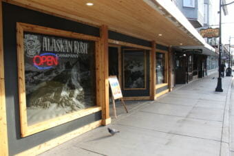 An open signs lights up the window of the Alaskan Kush Company in downtown Juneau. (Photo by Adelyn Baxter/KTOO)