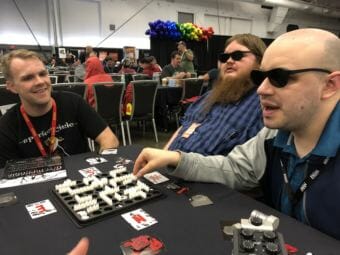 (From left) Judson Rusk, Calvin Drank and Seaton Bryan play Nyctophobia, a board game where players are unable to see the board. The three traveled to SHUX earlier this fall to try new board games and meet the creators of some of their favorites.