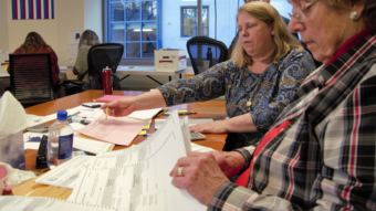 State Review Board members Lynda Thater-Flemmer and Stuart Sliter review ballots cast in the House District 1 election at the Juneau office of the Alaska Division of Elections on Nov. 23, 2018. Their review left the race in a dead tie -- with one ballot flagged for further investigation.
