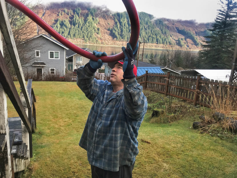 Phil Isaak, of Ike's Fuel finishes topping off a heating oil tank on November 15, 2018, in Juneau, Alaska. Isaak says costs in Alaska don't really match up well with heating fuel costs in the rest of the country. (Photo by Rashah McChesney/Alaska's Energy Desk)