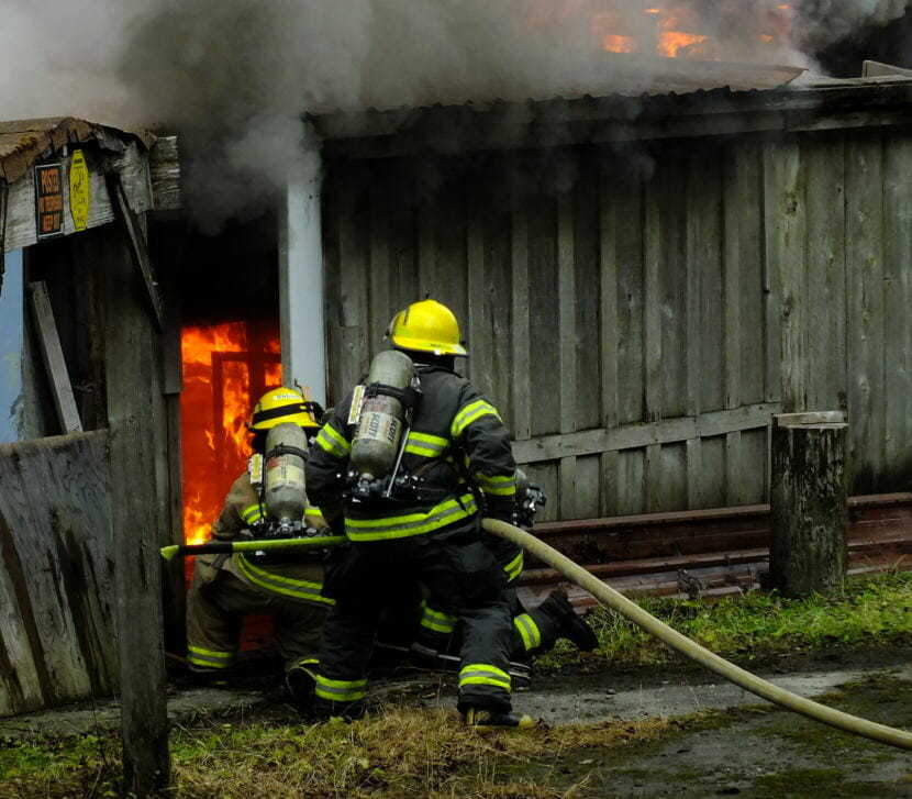 Capital City Fire/Rescue firefighters enter the Thane Ore House and attack an interior fire during the controlled burn on Nov. 24, 2018.