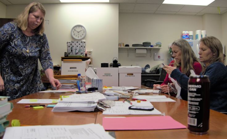 The State Review Board reviews general election ballots at the Juneau office of the Alaska Division of Elections on Nov. 23, 2018. The board members work in bipartisan pairs to certify the results.