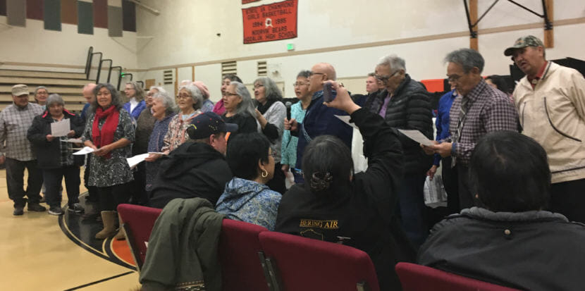 Noorvik elders sing the hymn Aarigaa to welcome Gov. Mike Dunleavy, Rose Dunleavy and other dignitaries, Dec. 3, 2018. (Photo by Andrew Kitchenman/KTOO and Alaska Public Media)