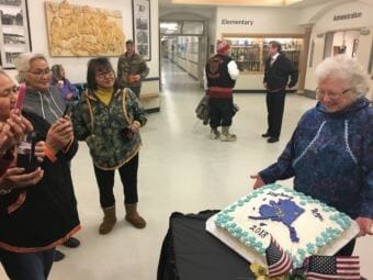 Donna Zibell shows off the cake she baked for Gov. Mike Dunleavy's inauguration celebration in Noorvik, Dec. 3, 2018. (Photo by Andrew Kitchenman/KTOO and Alaska Public Media)