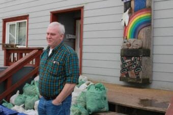 Jeff Feldpausch stands in front of bags of hemlock branches, ready for distribution to elders. He noted the bare spots on the branches, illustrating the annual need for subsistence coming up short.