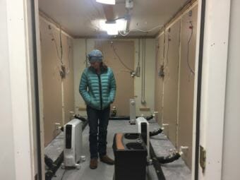 Research engineer Robbin Garber-Slaght in the Cold Climate Housing Research Center's mobile test lab. They're doing an experiment that they hope will lead to cheaper insulation retrofits that have low risk of mold. (Ravenna Koenig/ Alaska's Energy Desk).